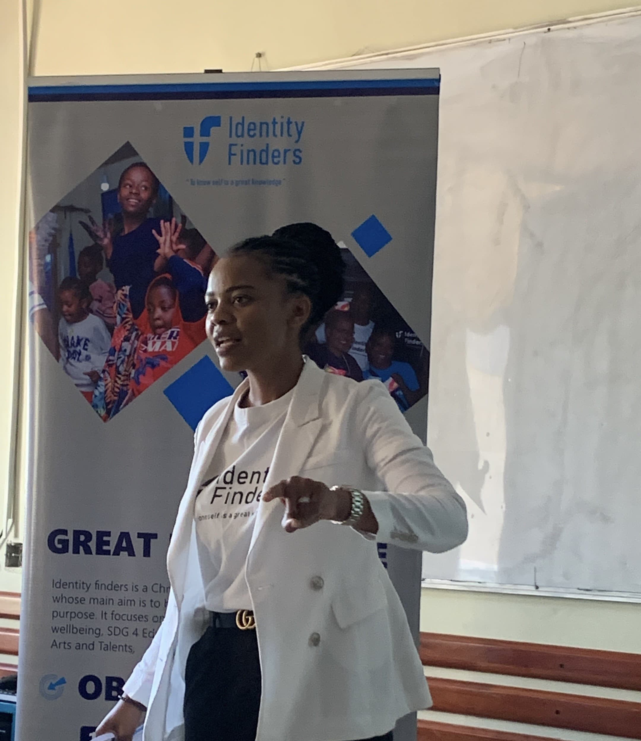 image of founder with banner giving speech